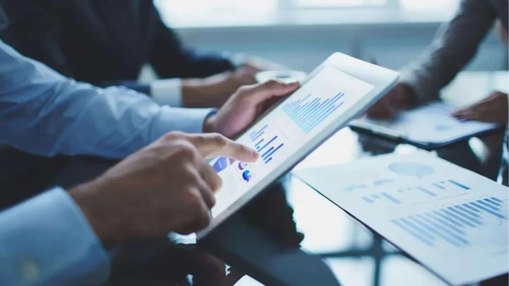 Businessman Using Tablet With Graphs